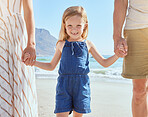 Portrait of little cute daughter holding her mother and fathers hand while having fun on the beach. A cute smiling little girl standing with her parents on vacation. Fun family vacation