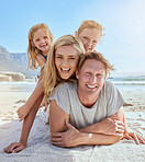 Portrait of a carefree family relaxing and bonding on the beach. Two cheerful little girls spending time with their parents on holiday. Mom and two daughters lying on top of dad enjoying vacation