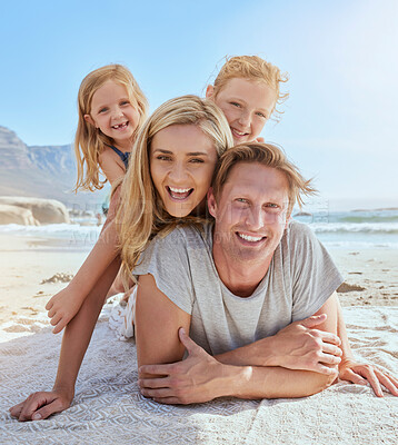 Buy stock photo Portrait of a carefree family relaxing and bonding on the beach. Two cheerful little girls having fun with their parents on holiday. Mom and two daughters lying on top of dad enjoying vacation