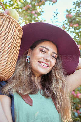 Buy stock photo Portrait of one happy woman holding basket of fresh picked apples from trees on sustainable orchard farm outside on sunny day. Face of cheerful farmer harvesting juicy organic fruit in season to eat