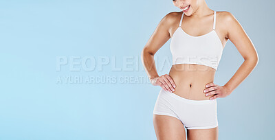 Buy stock photo Health, body and mockup with a model women in underwear on a blue background in studio to promote weightloss. Fitness, wellness and diet with a happy female posing for a healthy lifestyle