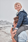 Beach, portrait of dad and child on shoulders with smile on family holiday or cloudy ocean walk in Australia. Travel, fun and happy father and son playing and walking at sea on vacation with gray sky