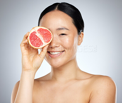 Buy stock photo Beauty, skincare and grapefruit with portrait of woman for wellness, health and vitamin c cosmetics. Smile, fruit and natural makeup with face of asian girl for nutrition, luxury and  facial product