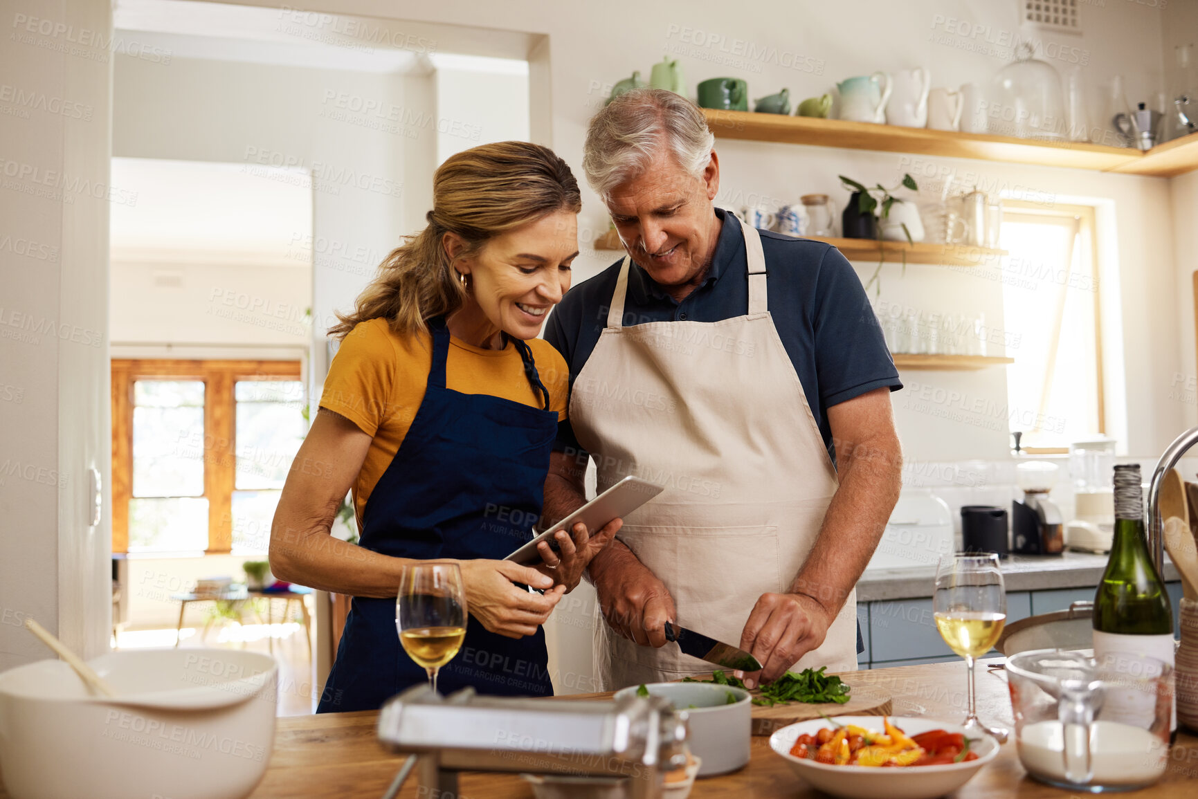 Buy stock photo Food, digital tablet and senior couple cooking in kitchen in their home, checking online recipe on internet. Love, family and meal with vegetables for health, wellness and nutrition while streaming