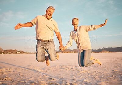 Buy stock photo Couple, beach and active seniors hold hands while jumping in sand, happy and excited at sunset. Love, family and freedom with mature man and woman jump in celebration of retirement, travel and energy