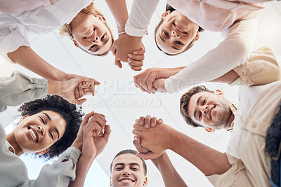 Buy stock photo Teamwork, support and collaboration of happy employees with diversity, synergy and trust holding hands and looking down. Men and women team building circle for mental health mission in workplace