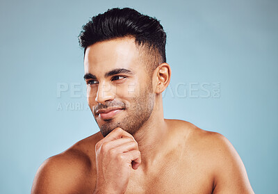 Buy stock photo Male beauty, skincare and health of India model thinking about dermatology, health and wellness on blue studio background. Face of man with smile for healthy skin after facial detox and self care