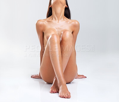 Buy stock photo Nude woman sitting cross-legged with her back arched, isolated on a white background