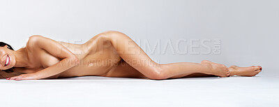 Buy stock photo Beautiful naked woman lying full-length on the floor - copyspace