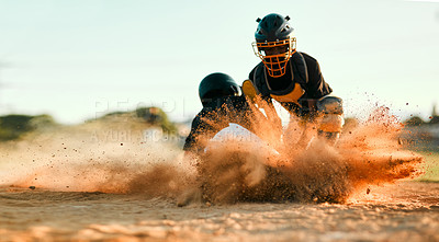 Buy stock photo A baseball player sliding into base, finally safe after an intense and dramatic game. A shortstop tagging out his competition during a sport match on the field. The more dirt, the more fun