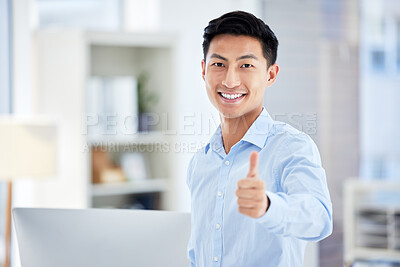 Buy stock photo Thumbs up, sign and finger being shown by a happy, smiling and pleased businessman while standing in an office at work. One young, satisfied and confident corporate professional making a hand gesture