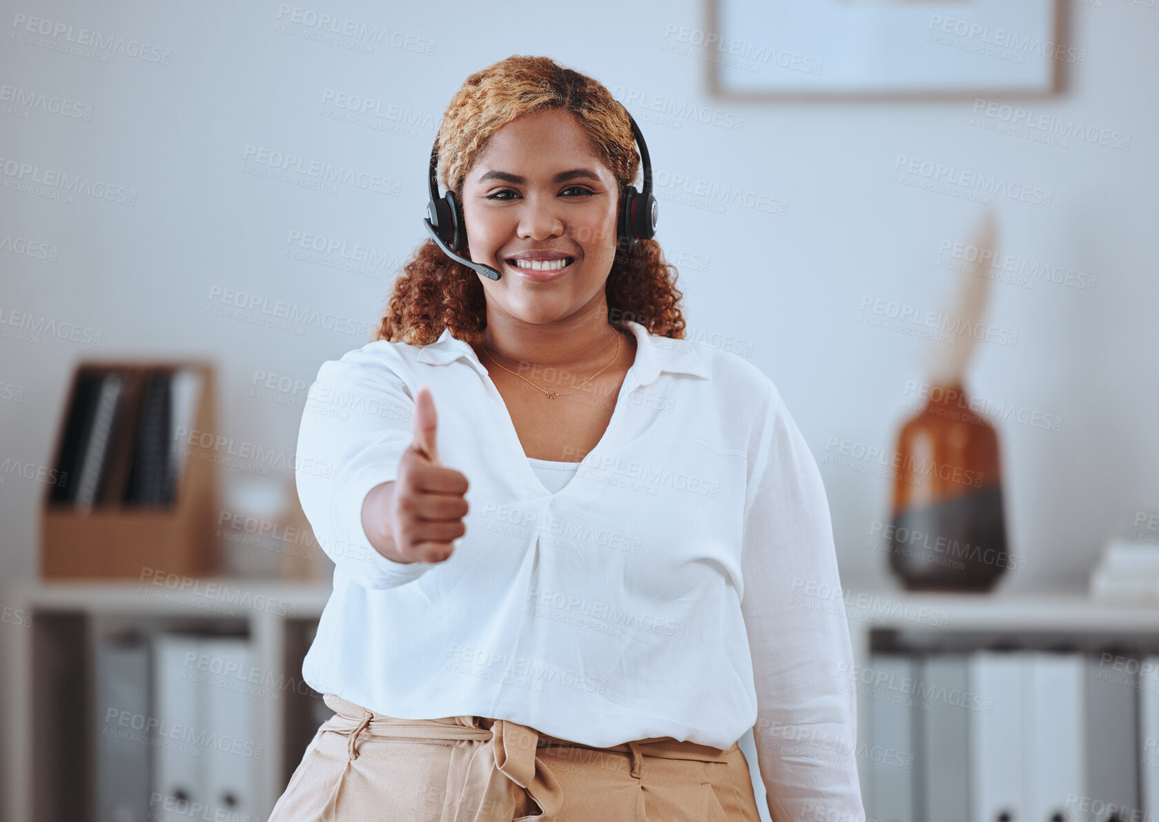 Buy stock photo Thumbs up from happy call center agent wearing a headset and smiling in an office. Portrait of cheerful worker showing a winning hand gesture while expressing joy about good internet, positive result