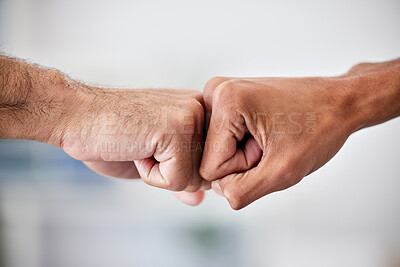 Buy stock photo United in victory and success, achieving goals by working together as a community. Closeup of business men fist bumping hands in the office. Welcoming, promoting or supporting a colleague