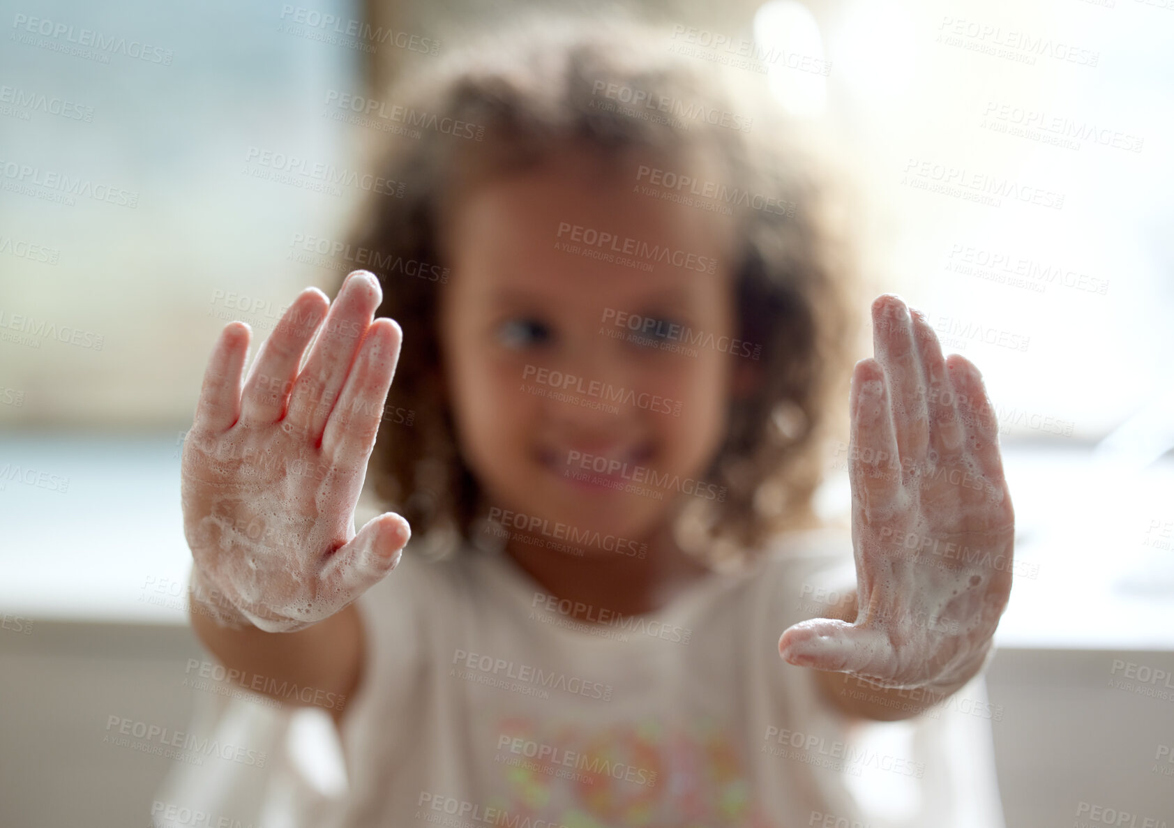 Buy stock photo Clean, hygiene and protection from infection by a little girl washing hands with foam soap. Portrait of a child showing soapy palms with sanitizer for virus and germ prevention