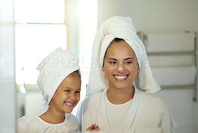 Buy stock photo Playful mother and daughter doing a hygiene, skincare routine together in the bathroom. Mom teaching her adorable child a grooming and beauty treatment regime. Parent and little girl applying lotion