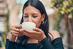 Portrait of woman holding a good warm drink outside. Peaceful, calm and stressless female sipping on white mug in hands in the outdoors. Closeup of carefree lady enjoying a hot beverage in fresh air.