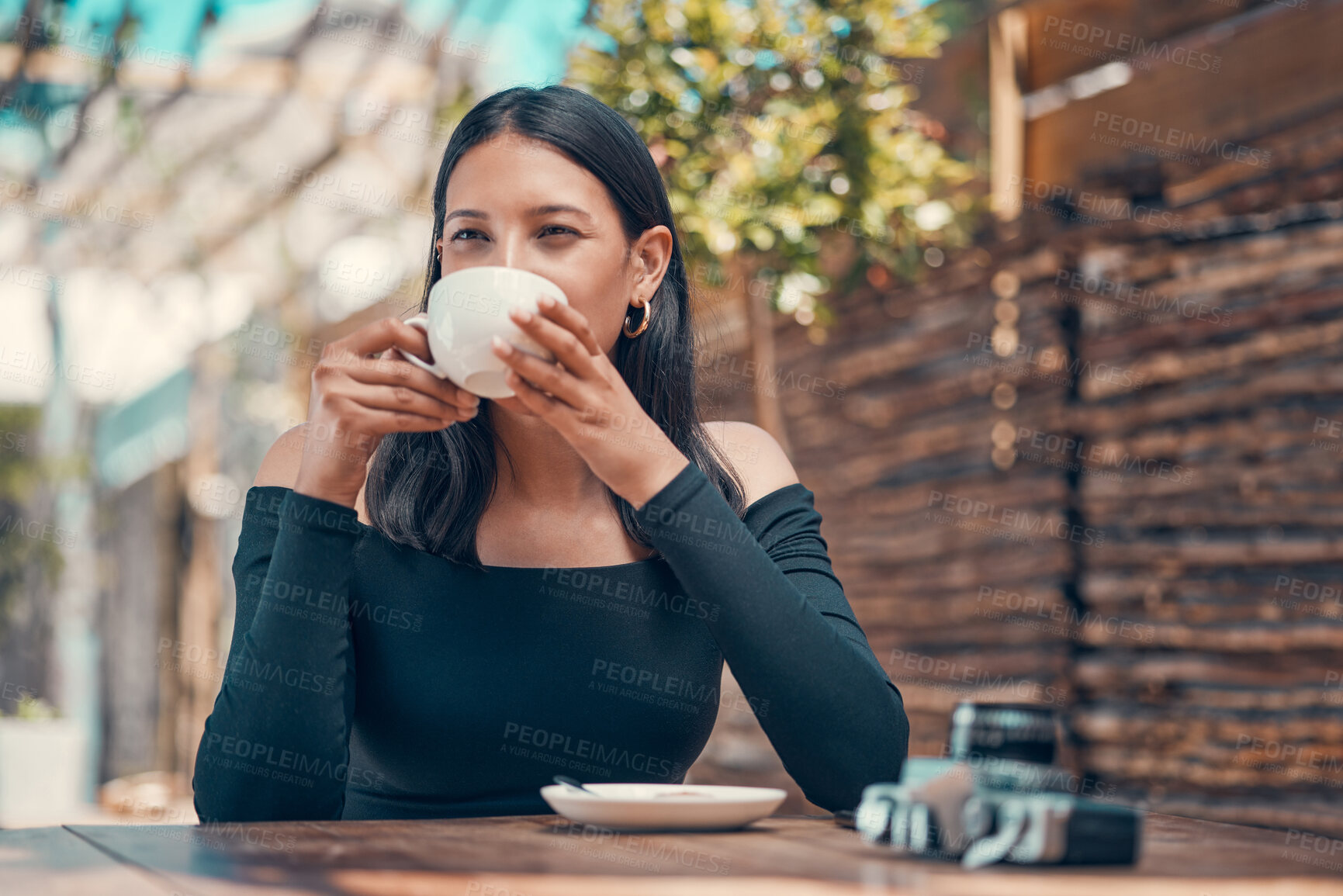 Buy stock photo Calm, relaxed and stylish woman taking a coffee break at an outdoor coffee shop in summer. One young entrepreneur or freelancer enjoying her free time drinking tea and relaxing outside