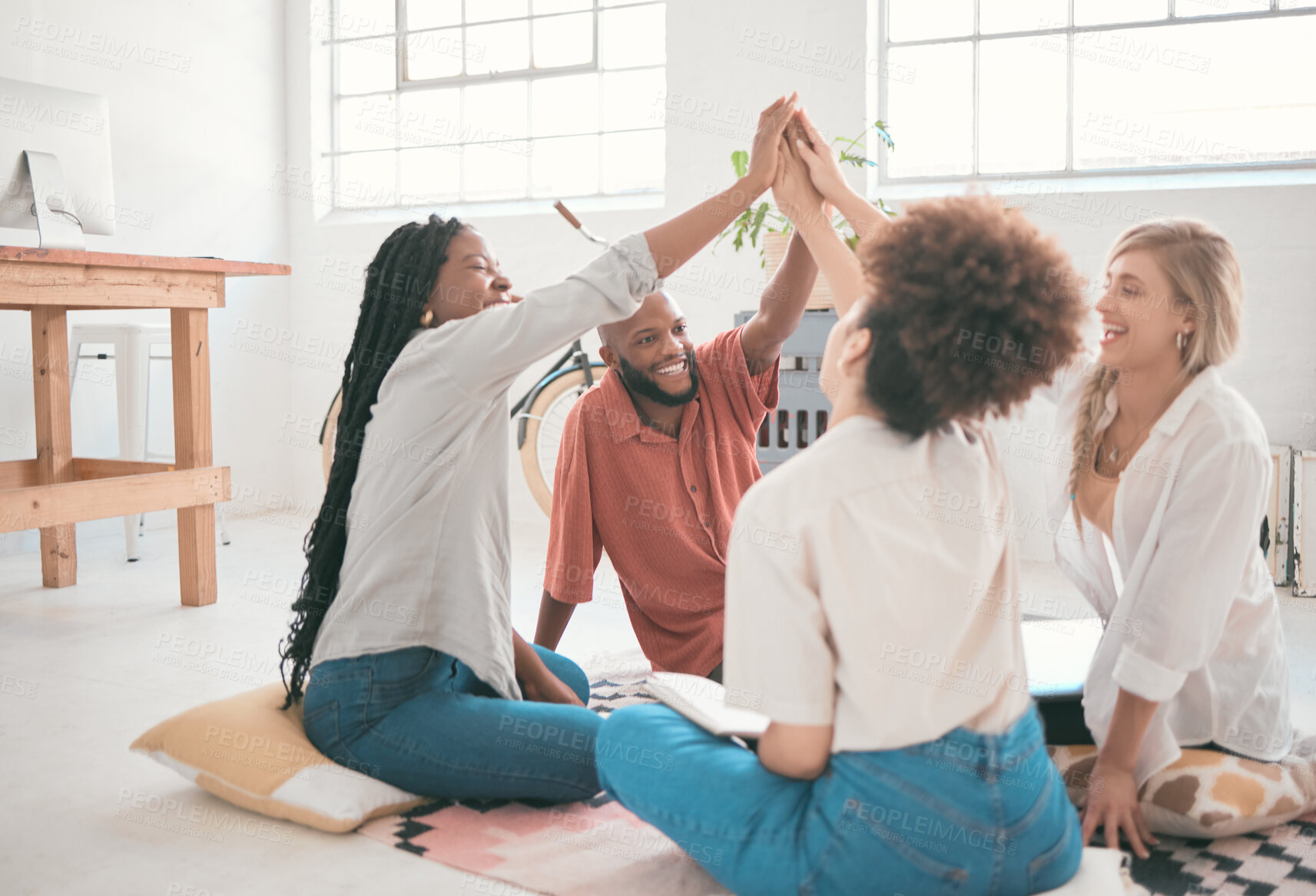 Buy stock photo Happy, excited and successful creative team celebrating with a high five after finishing or completing a task. Fun, diverse group of business colleagues cheering, feeling united and ready for success