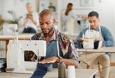 Buy stock photo Fashion, design and stylist or a young designer working with sewing machine. Busy, creative business employee creating new, trendy and fashionable clothes. Man at work with material in a workshop.