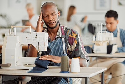 Buy stock photo Stressed, tired male designer in pain from a stress headache while working. A overworked creative worker with a deadline feeling burnout. Portrait of a fashion design adult student feeling sick