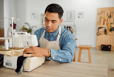 Buy stock photo Fashion designer, young man and creative student in a workshop designing clothes. Factory worker, tailor and apprentice learning sewing machine skills in a textile startup and manufacturing studio