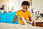 Testing for covid, corona virus or infection with a rapid antigen test kit at home. Young and casual woman unpacking a screening kit to diagnose an illness, sickness or infectious viral disease