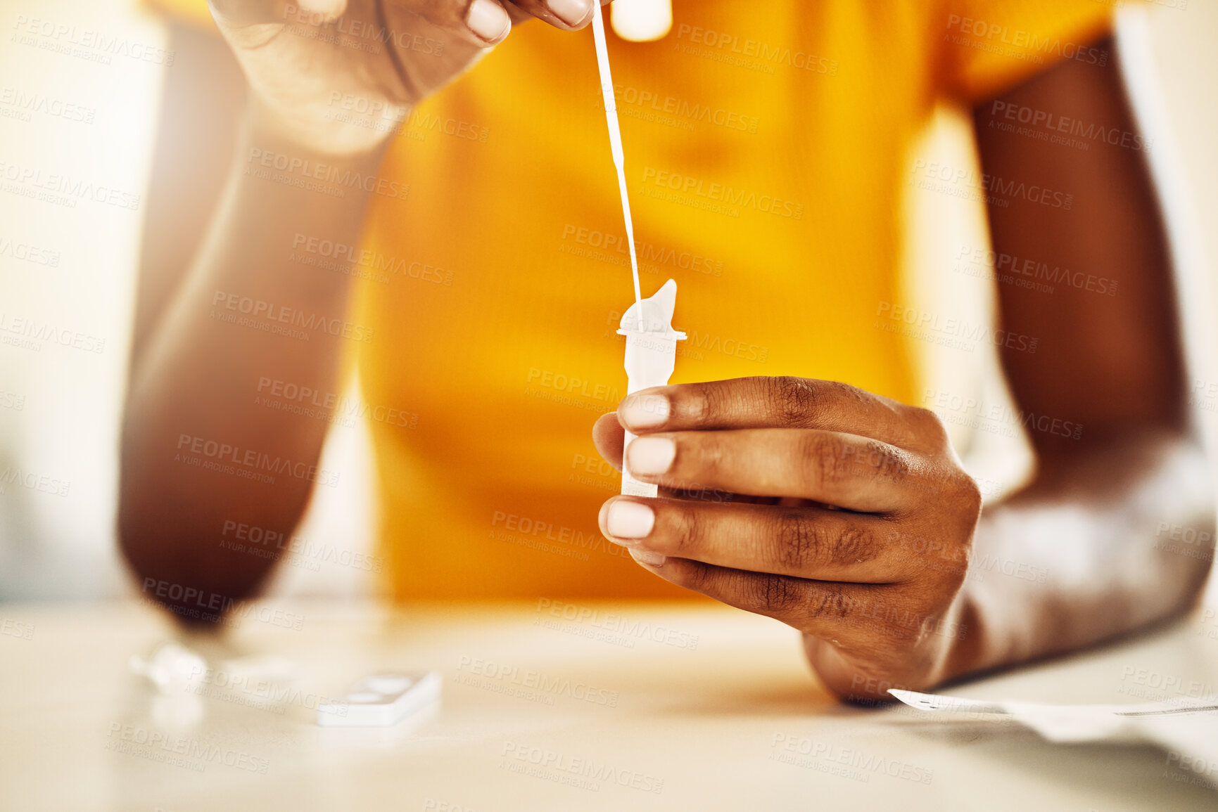 Buy stock photo Testing for covid, corona virus or infection with a rapid antigen test kit at home. Closeup of a casual woman screening herself with a kit to diagnose an illness, sickness or infectious viral disease