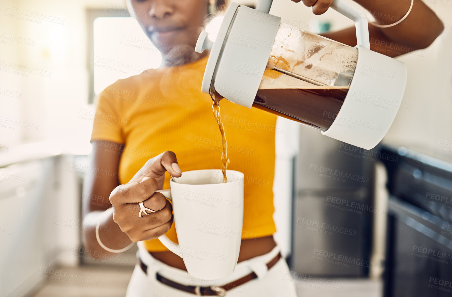 Buy stock photo Hands of woman pouring coffee into a mug, standing inside a kitchen at home. French press with homemade, fresh, and delicious warm drink to start the morning or day with a brewed caffeine beverage