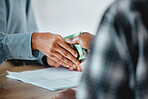 Illegal, suspicious payment and bribery in an office with documents on the table. Closeup of two business people's hands exchanging a cash payment in a corporate office to pay for a service illegally