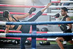 Fit, active and healthy boxing team kicking or fighting in workout, ring training or exercise in a wellness center. Sporty, athletic or strong man and woman kickboxing in combat fight or sports match