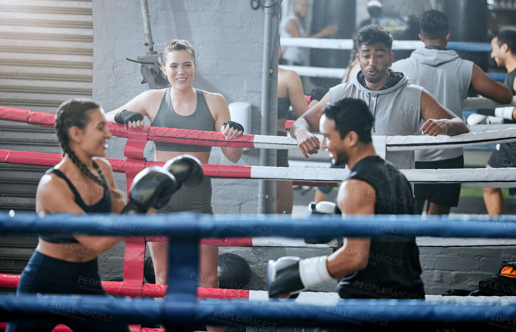 Buy stock photo Active, healthy and fit diverse boxing group training and working out together in a gym. Sports group doing a strength fight exercise while people watch. Smiling fitness team in a friendly workout
