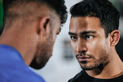 Serious, strong and fit male boxer, fighter or athlete staring, facing and looking tough inside. Closeup face of two men ready to challenge and battle in the boxing ring before a fight or competition