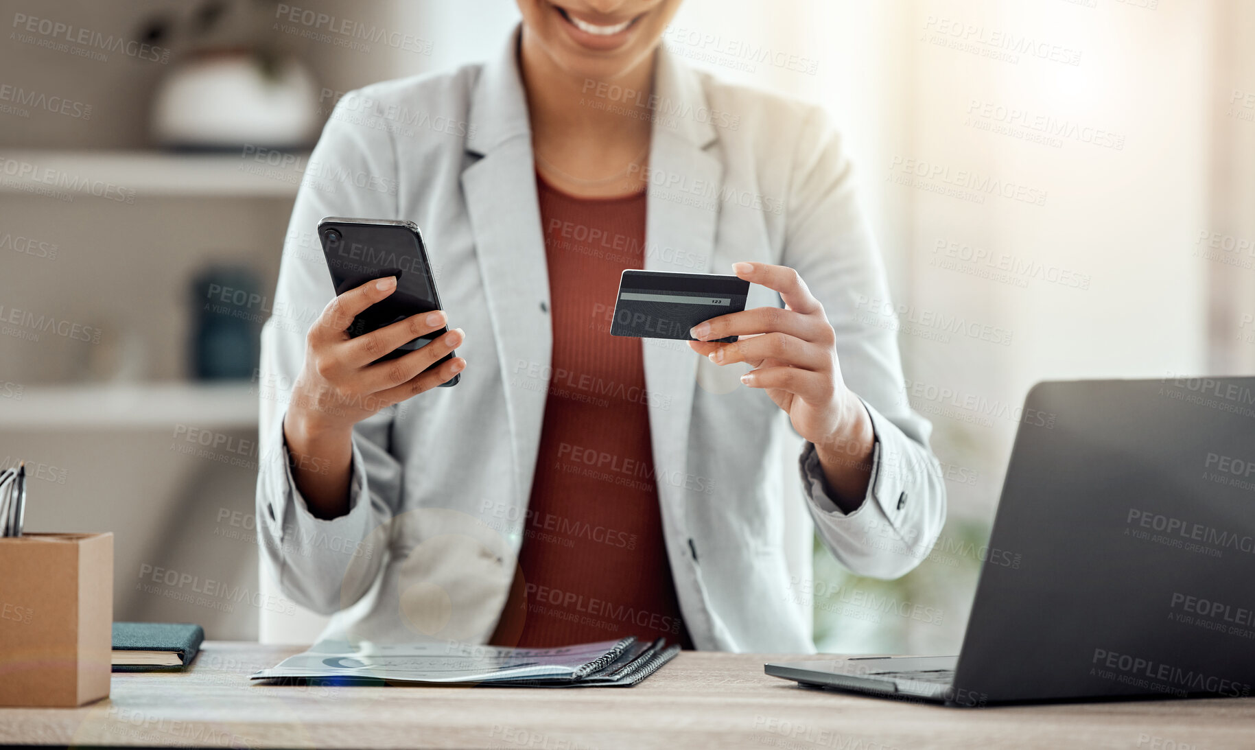 Buy stock photo Credit card and phone for shopping, buying and paying for products online on an app while sitting at work. Cheerful, excited and joyful professional banking, making payments and organizing finances