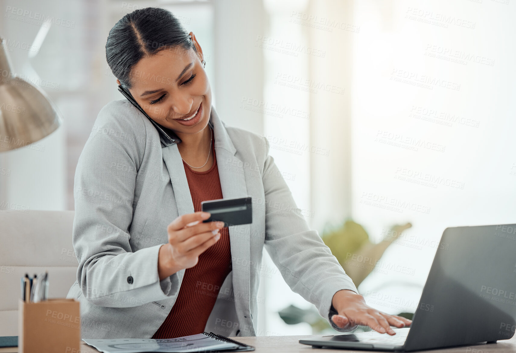Buy stock photo Business woman calling on phone while shopping online, paying and buying products or items with a laptop at work. Cheerful, joyful and content businessperson getting great customer service