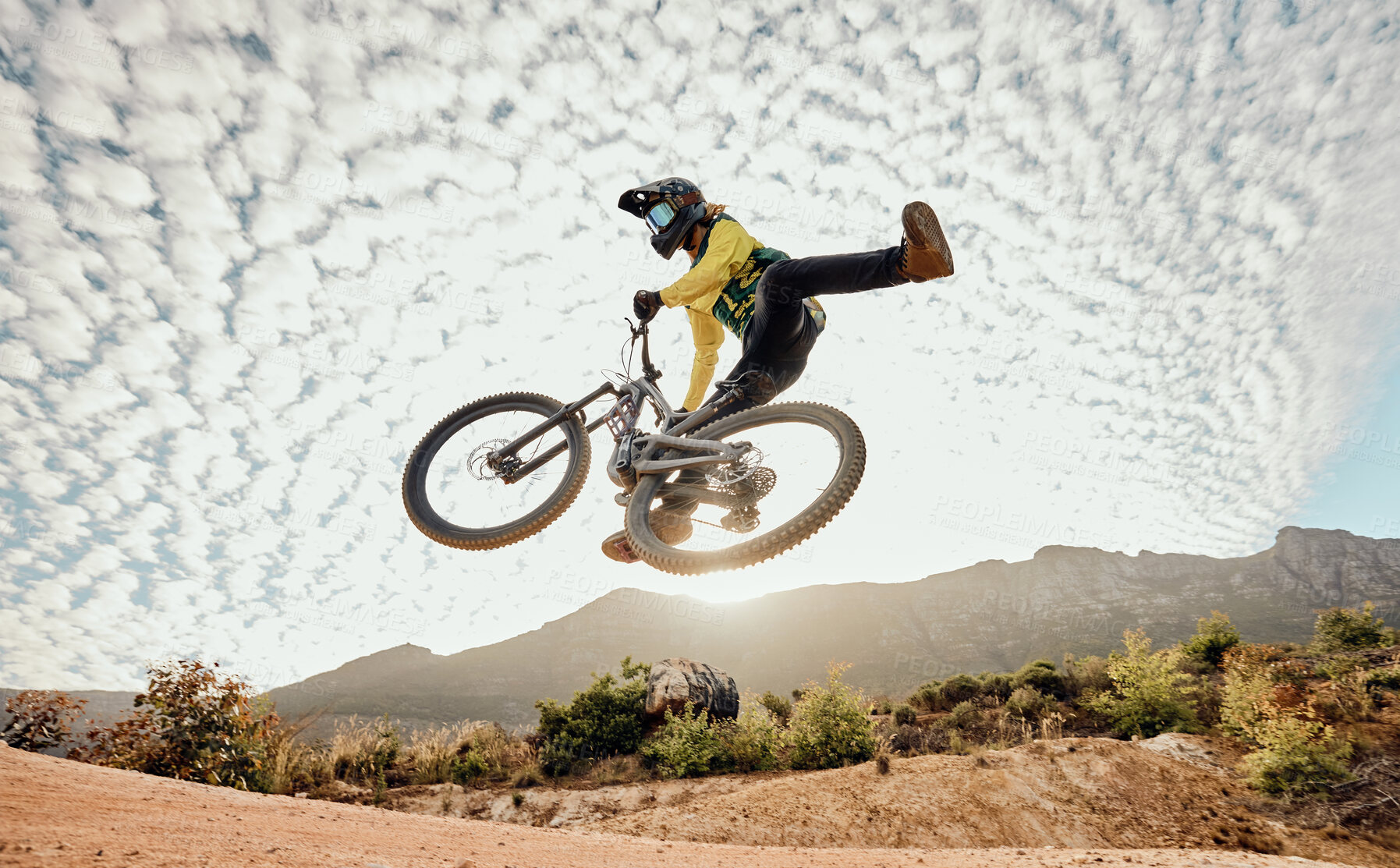 Buy stock photo Dessert, mountain bike and high jump trick for crazy fun competitive race, extreme sports performance and stunt freedom. Dirt biker flying in the air, adrenaline sport risk and awesome adventure ride