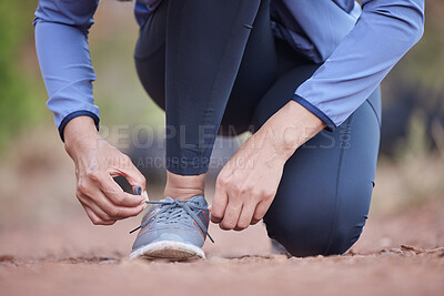 Buy stock photo Fitness, hands and running shoes in preparation for exercise, training or cardio workout in the nature outdoors. Hand of runner tying shoe laces getting ready for run, healthy exercising or trekking