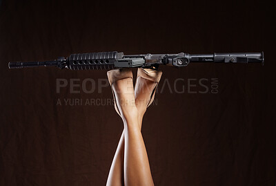 Buy stock photo Mafia, criminal and legs of a woman with a gun isolated on a black background in a studio. War, army and feet of a person in heels with a revolver for violence, crime and shooting on a dark backdrop