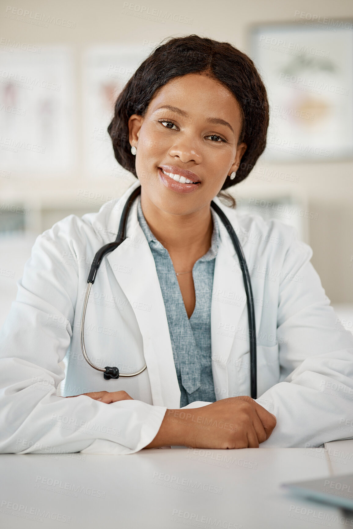 Buy stock photo Black woman doctor at her desk, happy and sitting at her office in a clinic or hospital. Success, work and a smile, young female healthcare professional or career medical worker, a leader in medicine