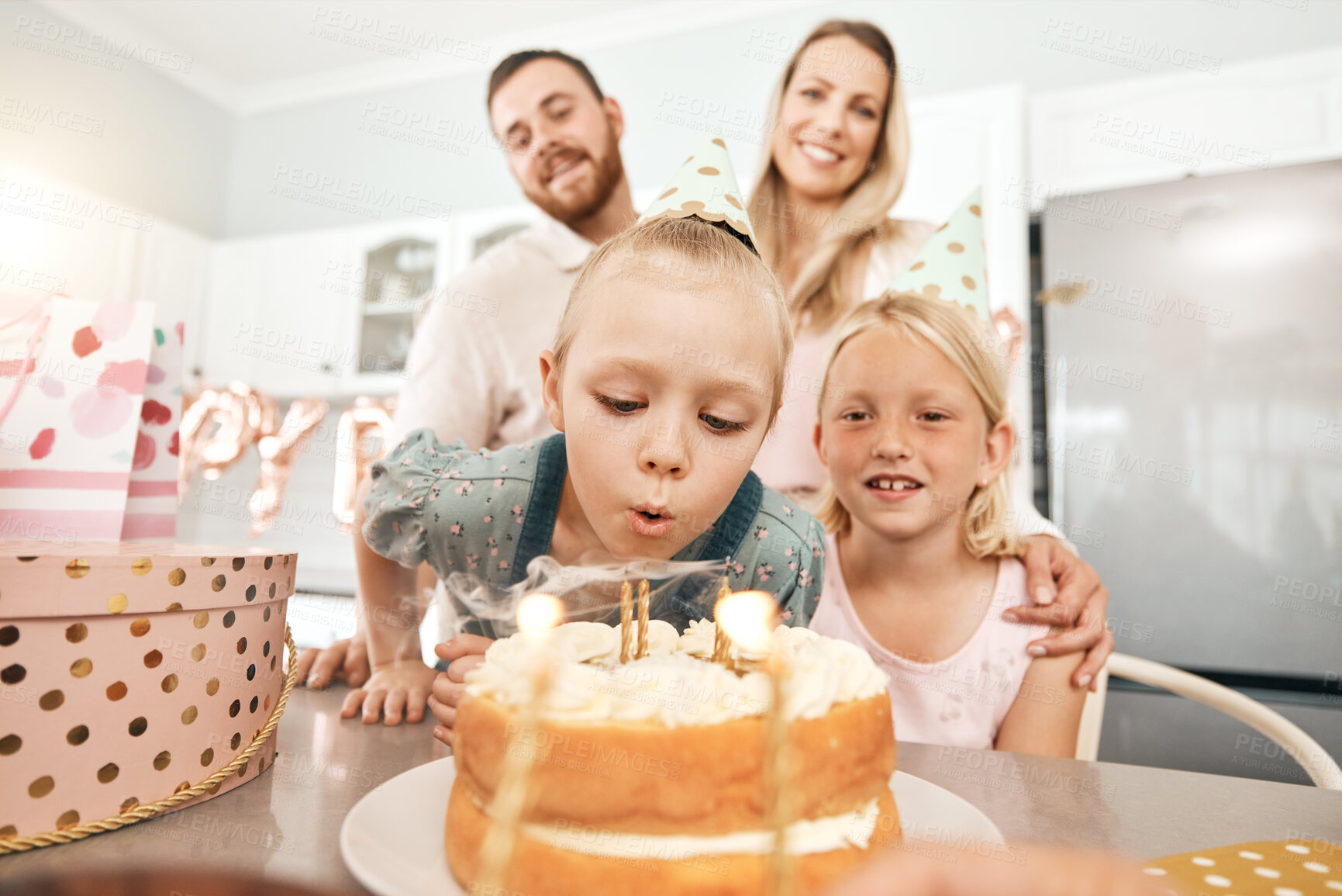 Buy stock photo Children birthday party, cake and candles for blowing out with mother, father or sister in home kitchen. Fun, excited or happy kids celebrating, enjoying and having fun with parents on special event