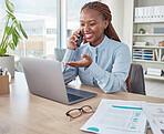 Businesswoman talking on phone call and browsing a laptop in an office. Female assistant smiling, discussing and networking with client while planning and scheduling appointments at a startup company