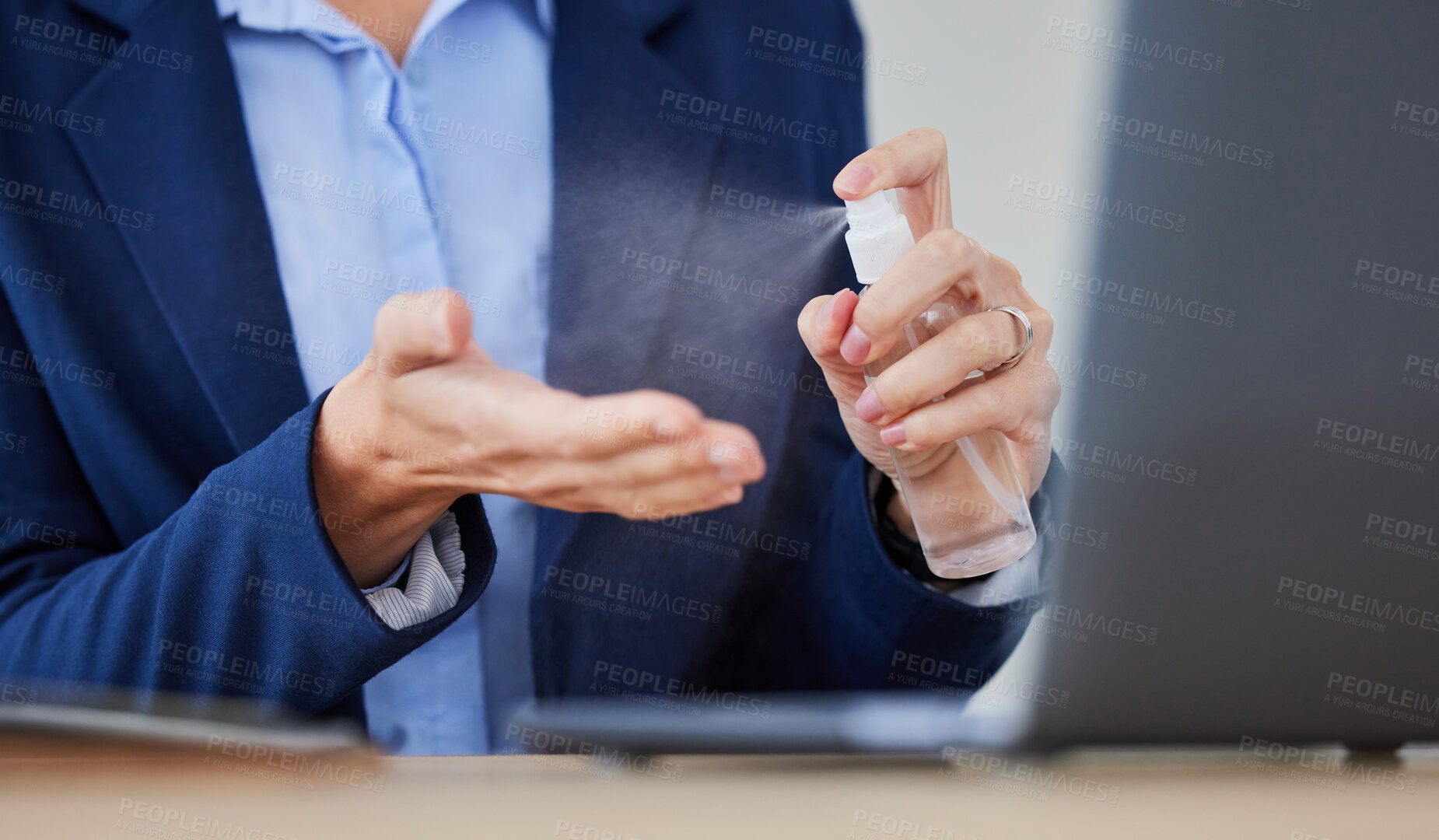 Buy stock photo Hygiene, health and businesswoman cleaning hands with sanitizer spray. Female disinfecting with an antibacterial agent at work. Lady spraying alcohol to clean because of covid, epidemic or pandemic.