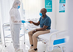 Black man talking to medical doctor, wearing mask to protect from covid and getting wellness advice. Expert, professional or healthcare worker helping patient, doing checkup and giving brochure