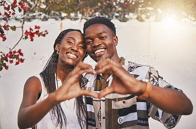 Buy stock photo Happy couple heart love sign with their hands posing for a picture or photo while on vacation or holiday. Portrait of a loving and young African American lovers having fun together smiling in joy