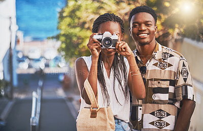 Buy stock photo Travel, tourism and young black couple taking photo on a camera, having fun and walking in a city. African american boyfriend and girlfriend bonding, enjoying their relationship and journey together 