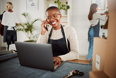 Buy stock photo Designer talking on phone call, taking orders on laptop and working at a factory, fashion boutique or studio at work. Smiling and happy tailor, worker or stylist making conversation with supplier