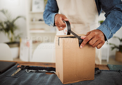Buy stock photo Packing parcel, package or delivery order with black tape while packaging, boxing and wrapping product. Closeup of a small business owner or tailor wrapping a box for courier shipping or selling