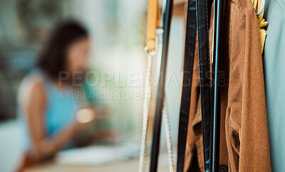 Buy stock photo Fashionable clothes, wardrobe display and boutique collection hanging on store rail with designer, stylist and woman working in the background. Closeup of trendy clothing design in a creative startup
