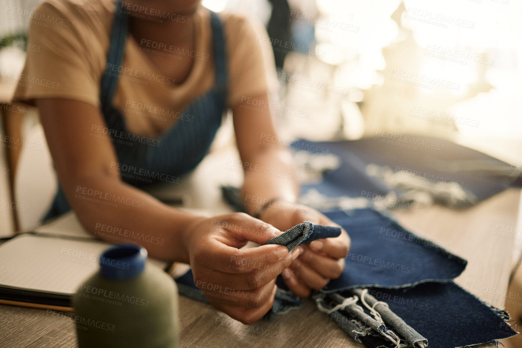 Buy stock photo Fashion design student sewing, learning and making creative denim clothes in a clothing manufacturing factory. Industry, artistic and fashionable designer busy in a workshop working on stylish jeans