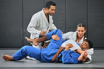 Buy stock photo Mma, martial arts and exercise with a coach, teacher or instructor instructing students during practice, training or sparring in a gym or dojo. Fighting and self defense class for health and fitness