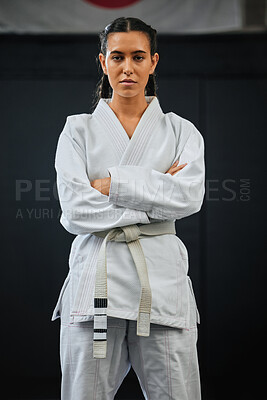 Karate pro, women empowerment and training mindset of a serious, learning sport student. Portrait of a fight and fitness athlete with focus in a sports studio, dojo school or martial arts gym